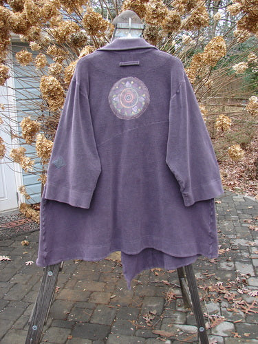 2000 PMU Celtic Moss Highlander Coat Aubergine Size 1: A patched coat made from soft, heavy Celtic Moss fabric. Features empire waistline, diagonal back, front buttons, multiple patches, and big collared front. Bust 56, Waist 62, Hips 72, Hem Circumference 90, Front Length 46, Back Length 39.