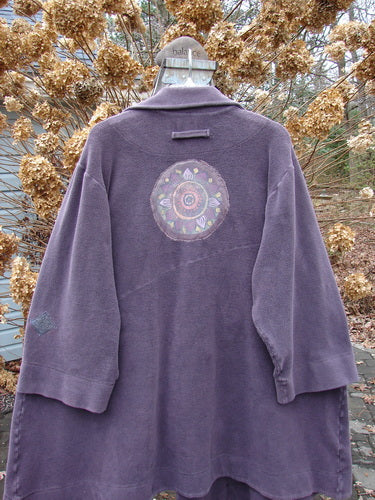 2000 PMU Celtic Moss Highlander Coat Aubergine Size 1: A plush purple coat with a unique design. Empire waistline, diagonal back, and multiple patches.