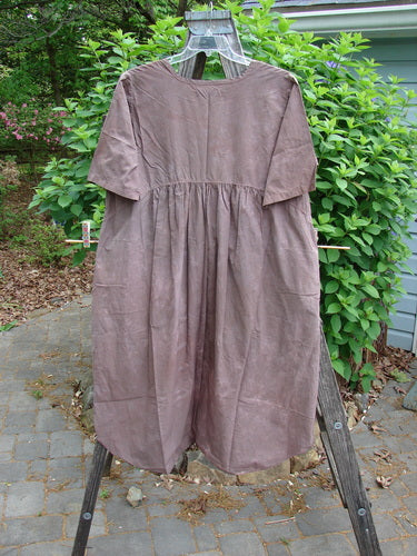 Barclay Percale Key Pocket Hi Low Dress in Mottled Mocha, features a key neckline, dual drop pockets with elastic, rounded hem, and wide sleeves, embodying Bluefishfinder.com's vintage, expressive style.