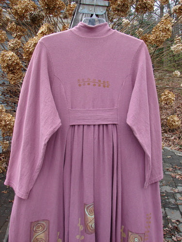 1996 Reprocessed Equinox Coat: A pink dress with long sleeves, a widening lower bell shape, and deep side pockets. Made from thick, textured cotton.
