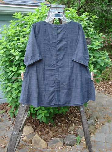 Barclay NWT Chambray Short Sleeved Promotional Top Striation Dark Denim Size 0 on a clothes rack, showcasing its graduating A-line shape and rounded neckline, reflecting Bluefishfinder.com's vintage-inspired style.