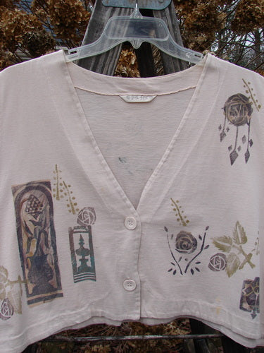 A white shirt with a design on it, featuring a continuous rose and leaf theme. The shirt is a 1994 Spruance Vest Tri Roses Mist OSFA from the Winter Collection.