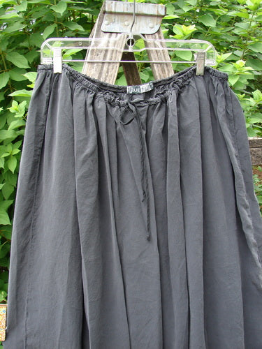Barclay Silk Drawstring Bell Skirt Unpainted Raven OSFA elegantly displayed on a clothesline, highlighting its graceful bell shape and drawstring detail, reflecting the vintage charm of Bluefishfinder.com's unique collection.