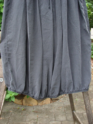 Barclay Silk Drawstring Bell Skirt Unpainted Raven OSFA featured on a clothes rack, showcasing its elegant drape and unique design, embodying Bluefishfinder.com’s ethos of vintage-inspired, expressive fashion for women.