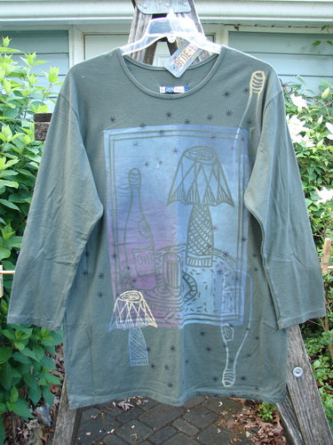 Barclay NWT Long Sleeved Studio Tee in Shadow Garden Green, features a straight shape with cozy long sleeves, rounded neckline, and Cheers Celebration theme, suitable for size 0 from Bluefishfinder.com.