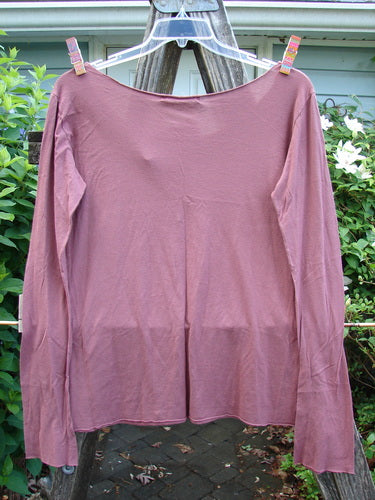 Barclay NWT Modal Batiste Layer Top in Desert Rust, featuring long narrowing sleeves, raw edges, and a rounded neckline, exemplifies BlueFishFinder.com's unique vintage style, promoting individual expression and creativity.