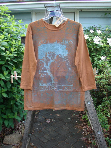 Barclay NWT Long Sleeved Studio Tee features a straight shape, cozy long sleeves, and a rounded neckline with an ABC tree theme in ochre. Made from medium-weight organic cotton, size 0.
