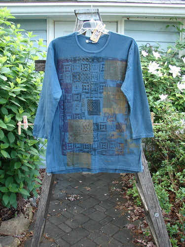 Barclay NWT Long Sleeved Studio Tee features a straight shape, cozy long sleeves, and a rounded neckline with a holiday mosaic metallic theme, embodying Bluefishfinder.com's ethos of creative individuality.