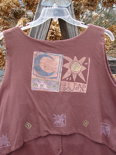 1989 Folk Vest with Sun and Moon design, made from double layered cotton. Features include mix and match buttons, front tuxedo tails, and a V-shaped neckline. Bust 50, waist 48, lengths 20-26 inches. Vintage collectible from Blue Fish.