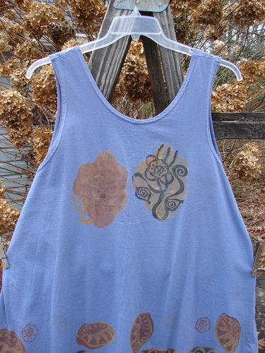 1993 Solo Tank Wonderland Periwinkle OSFA: A blue tank top with a painted design on it. Features a rounded lower cut, deep arm openings, and a unique vertical center front seam. Perfect for a super short dress or longer tank.