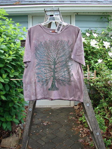 Barclay NWT Fiona Straight Tee displays a Tree Star design on a Mottled Grey Plum backdrop. It features a rounded neckline, wide sleeves, and a generous straight cut, embodying Bluefishfinder's vintage style.