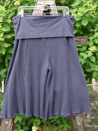 Barclay Thermal Fold Over Crop Pant Unpainted Deep Violet Size 1 displayed on a wooden ladder, showcasing its drapey, wide-leg silhouette and fold-over waistband, ideal for yoga or dance.