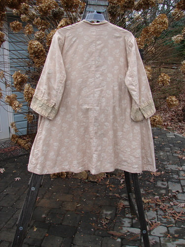 A Magnolia Pearl European Cotton Snap A Line Cardigan Floral Mix OSFA. A coat on a swinger with 3 sleeve spots. SPOT REMOVAL.