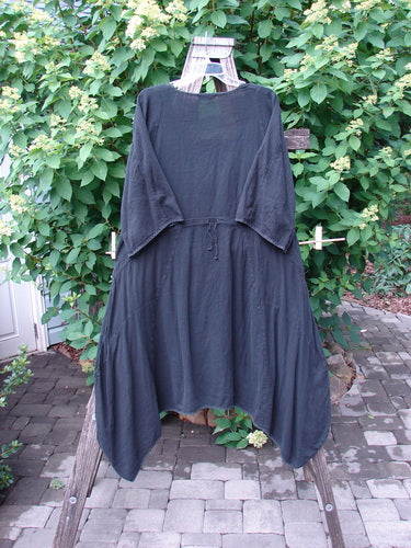 Barclay Gauze Urchin Bell Dress Unpainted Black Size 1 displayed outdoors on a wooden ladder, featuring a loose fit, three-quarter sleeves, and a simple waist tie, embodying Bluefishfinder's vintage, expressive style.