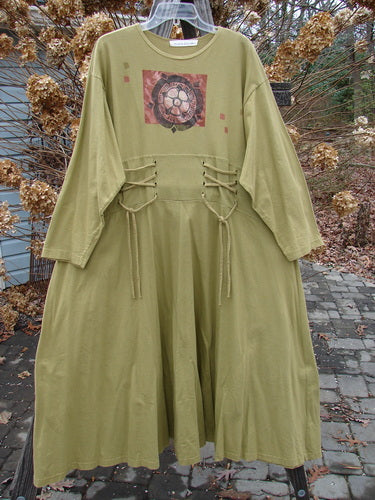 1997 Caryatid Dress with green design on organic cotton, featuring adjustable laces and oversized lower accentuating drape and swing.