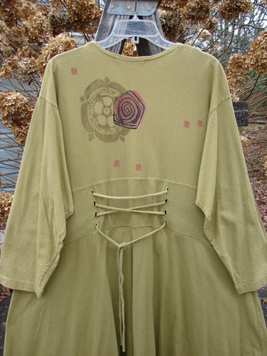 1997 Caryatid Dress with green design, lace accents, and abstract theme paint. Size 2 lantern, made from organic cotton. Versatile and flattering vintage piece.