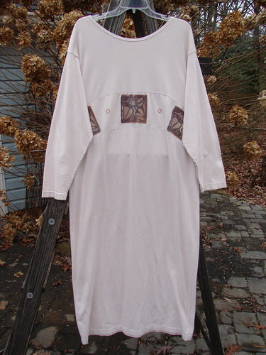 1995 Empire Dress Heart Leaf Champagne Size 1: White long-sleeved shirt on a swinger, with a pattern, wood plank, and glass close-ups.