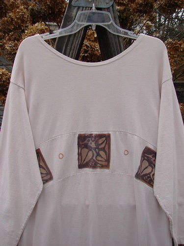 1995 Empire Dress Heart Leaf Champagne Size 1: A white shirt with a brown leaf design, featuring a specialized curved waist panel and slightly tighter lower sleeves.