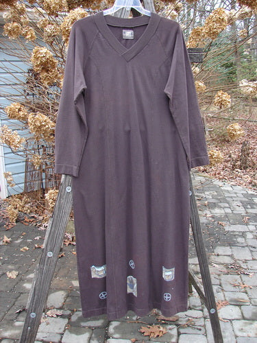 1999 Wide V Neck Dress with Rocking Horse Patch, Size 1: Slimming purple dress on clothes rack, featuring ribbed V neckline and sectional panels.