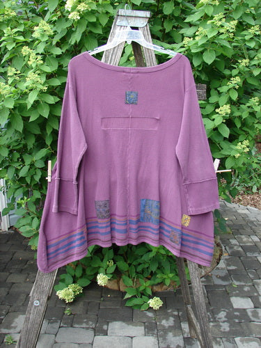 Barclay Patched Thermal Single Button Cardigan Tiny Square Murple Size 1 displayed on a wooden hanger, showcasing its unique patch details, single button closure, and curved stitchery against a natural outdoor setting.