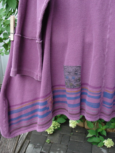 Barclay Patched Thermal Single Button Cardigan Tiny Square Murple Size 1, features a single wooden button, pink and blue hem stripes, floral patch, and curved stitchery, hanging outdoors.