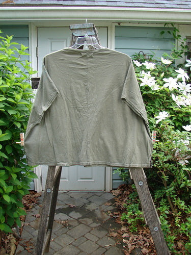 Barclay Cricket Cap Sleeve Tee Script Garden Bottlecap OSFA features a boxy shape with cap sleeves, a rounded hemline, and seamless shoulder sleeves, showcasing a unique garden theme design.