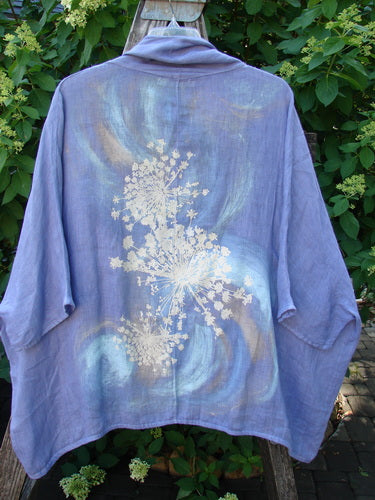 Barclay Linen Open Front Cheerful Cardigan Jacket Rear Starburst Iris Size 1, featuring dolman sleeves and a unique botanical motif, draped elegantly outdoors over a wooden ladder.