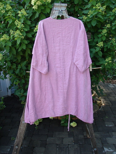 Barclay Linen High Vent Venetian Dress Center Leaf Peony Rose Size 1, showcased on a clear hanger over a wooden step-ladder, features a softly dipped V neckline and high side vents.