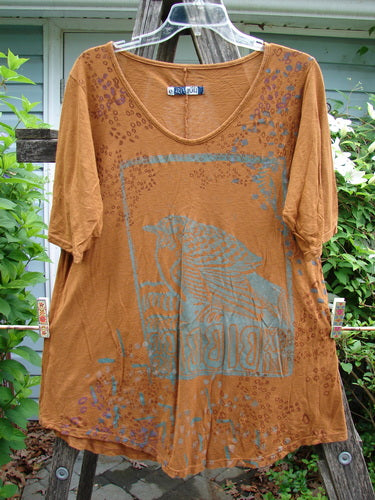 Barclay Slub Curve Bottom Tee in Bird Window Ochre, Size 0 features a rounded flattened neckline, short sleeves, A-line shape, and varying hemline, exemplifying Bluefishfinder.com's vintage-inspired, expressive style.