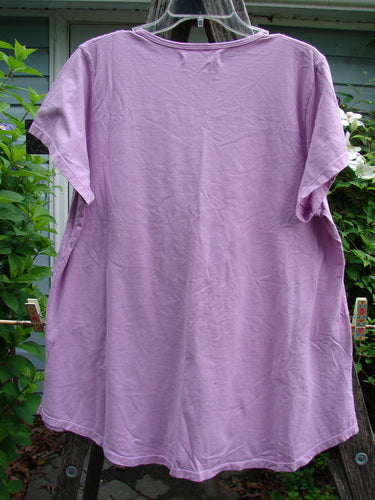 Barclay Short Sleeved Travel Tee Continuous Turn Pink Peony Size 1 features a rounded neckline, slightly longer cap sleeves, and an A-line shape with a varying hemline, emphasizing casual elegance.