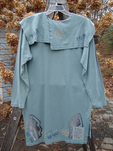 1996 Trifocal Top Celestial Trinket Size 1: Long-sleeved shirt on clothes rack, with unique forest-themed paint design and Blue Fish patch.