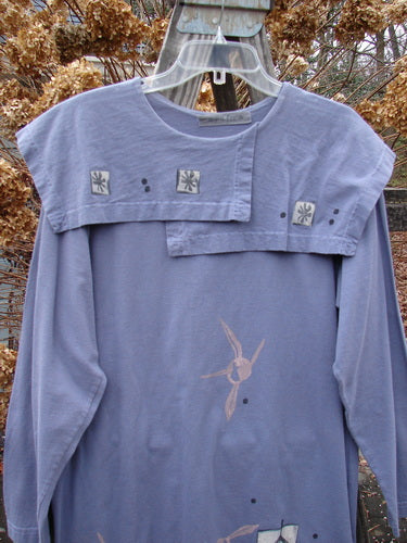 1996 Trifocal Top with rabbit design on blue shirt, featuring folded collar, abstract arrow theme paint, and fish patch.