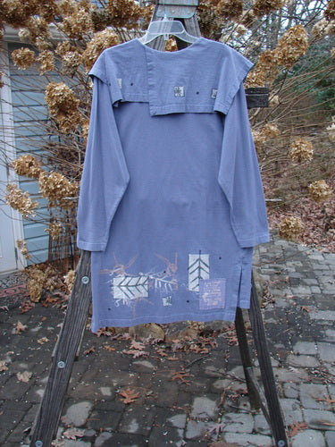 1996 Trifocal Top with an abstract arrow design on blue shirt, featuring a longer shape, vented sides, and folded collar.