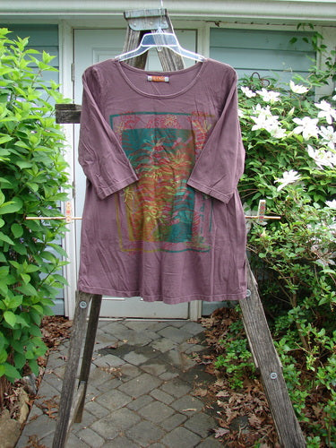 Barclay Three Quarter Sleeved Cafe Tee Water Lily Fig Size 1 features a rounded, thinly ribbed neckline, slight A-line shape, and three-quarter sleeves, showcasing a water lily theme in organic cotton.