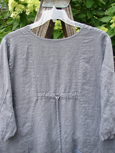 Barclay Linen Pinch Sleeve Curve Tie Back Top in Border Twig Grey, size 1, displayed on a hanger amidst green foliage, showcasing its loose fit and long sleeves, embodying Bluefishfinder.com's vintage charm.