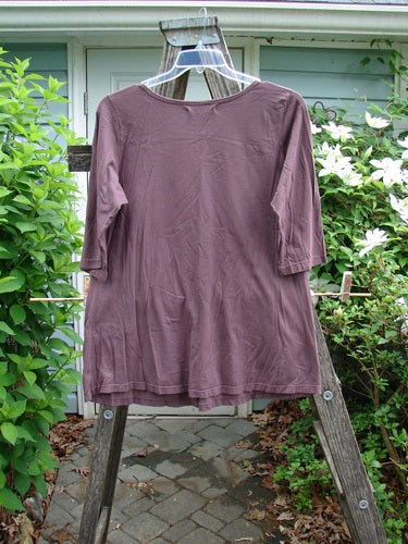 Barclay Three Quarter Sleeved Cafe Tee in Fig features a rounded, thinly ribbed neckline, slight A-line shape, and water lily theme paint, reflecting Bluefishfinder's unique vintage style.