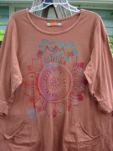Barclay Banded Artist Pocket Top Sunflower Rust Size 1, featuring a rounded neckline, A-line shape, diagonal double pockets, and three-quarter banded sleeves, embodies vintage Blue Fish creativity and individuality.