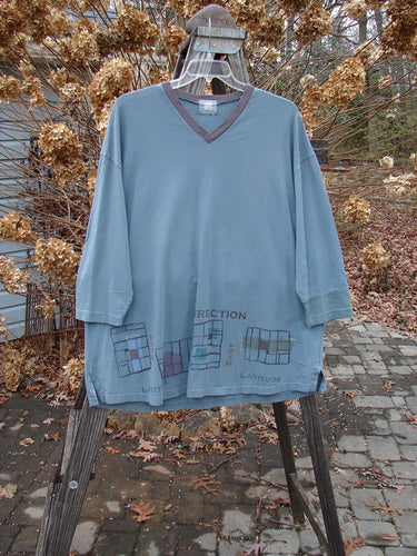 2000 V Neck Grid Top in Puddle, oversized 1. Organic cotton shirt on a swinger with unique paint and contrasting cuff. A-line shape, vented sides, rounded bottom sweep, and Blue Fish patch. Bust 54, waist 54, hips 54. Length 32.