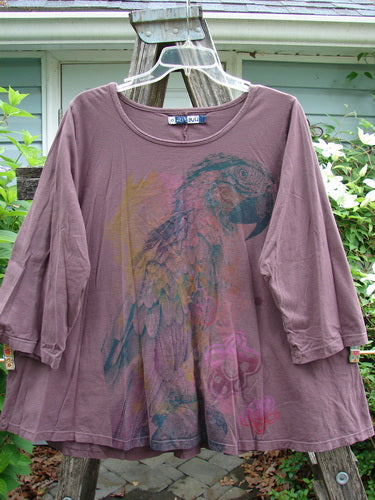Barclay Three Quarter Sleeved A Line Tee in Fig, showcasing a unique parrot theme, features a rounded neckline and flat edgings, embodying Bluefishfinder's vintage-inspired creative fashion ethos.