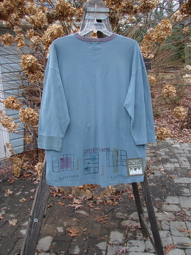2000 V Neck Grid Top in Puddle, Size 1: Organic cotton shirt with unique paint design, contrasting cuff, and V neckline. A-line shape with vented sides and Blue Fish patch. Bust 54, Waist 54, Hips 54, Length 32.