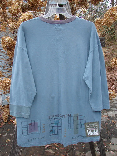 Blue Fish 2000 V Neck Grid Top in Puddle, an oversized organic cotton shirt with unique painted details, contrasting cuffs, and a signature blue fish patch.
