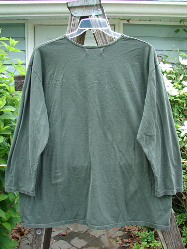 Barclay Long Sleeved Studio Tee Primitive Times Army Green Size 1 features a straight shape, long sleeves, and a rounded neckline. Made from medium-weight organic cotton, it embodies a vintage, artistic theme.