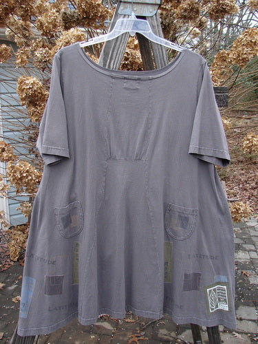 2000 Café Dress with swingy A-line shape and painted pocket on clothes rack.