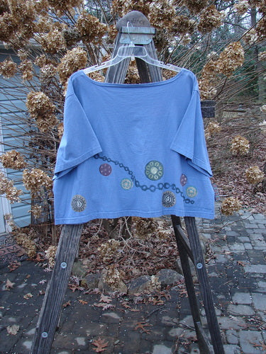 1993 Travel Top with pinwheel design on periwinkle cotton. Crop shape, scoop neckline, ceramic glazed buttons. Size 2.