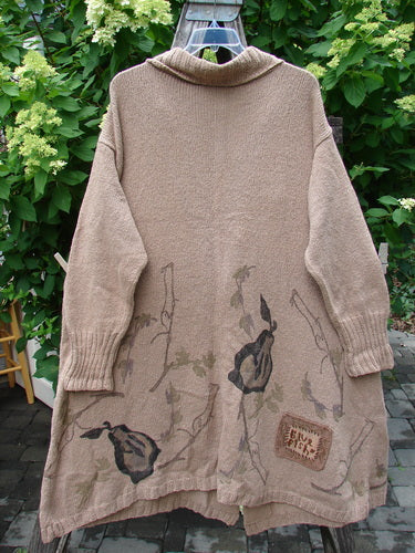 1998 Cotton Knit Canyon Cardigan Sweater Coat Pear Harvest Aspen OSFA with a long, taupe knit, floral motif, and ribbed V-neck, displayed on a hanger outdoors, highlighting its vintage charm and impeccable craftsmanship.