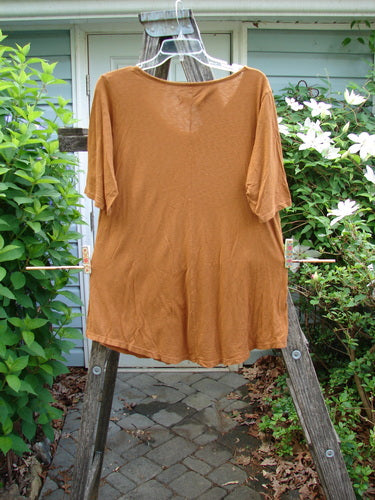 Barclay Slub Curve Bottom Tee Bird Window Ochre Size 0, featuring a rounded flattened neckline, short sleeves, A-line shape, and rounded hemline, showcasing a unique Bird in the Window theme.