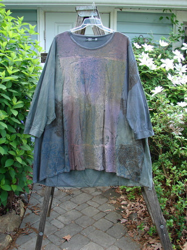Barclay Banded Oversized Art Top in Mottled Grey features a loose fit with drop shoulders, three-quarter sleeves, a rounded neckline, and varying hemline, showcasing a tight floral grid pattern. Perfect for fall.