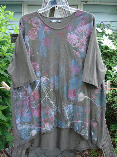 Barclay Tournesol Tunic Seed Pod Garden Stick OSFA showcasing a mid-length design with drop shoulders, loose three-quarter sleeves, and a varied hemline featuring a seed pod and floral blossom motif.