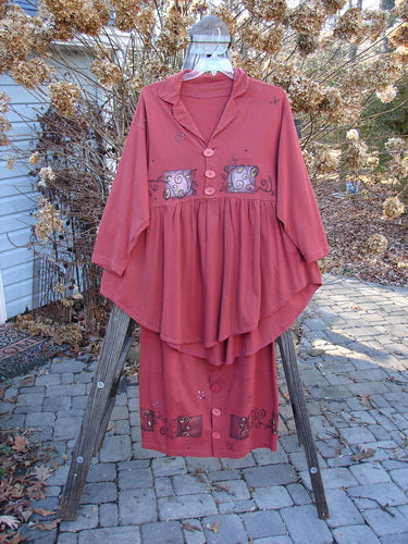 1997 Hearth Peplum Button Duo Vines Brick Size 2: Red dress, shirt, and skirt on rack and ladder, person wearing helmet, stone walkway.