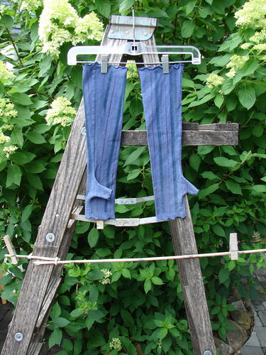 Barclay Cotton Lycra Hemp Fingerless Glove Stripe Royal Orchid OSFA hangs drying on a garden ladder, showcasing its rib-knit design with thumb-holes and flattering arm fit.